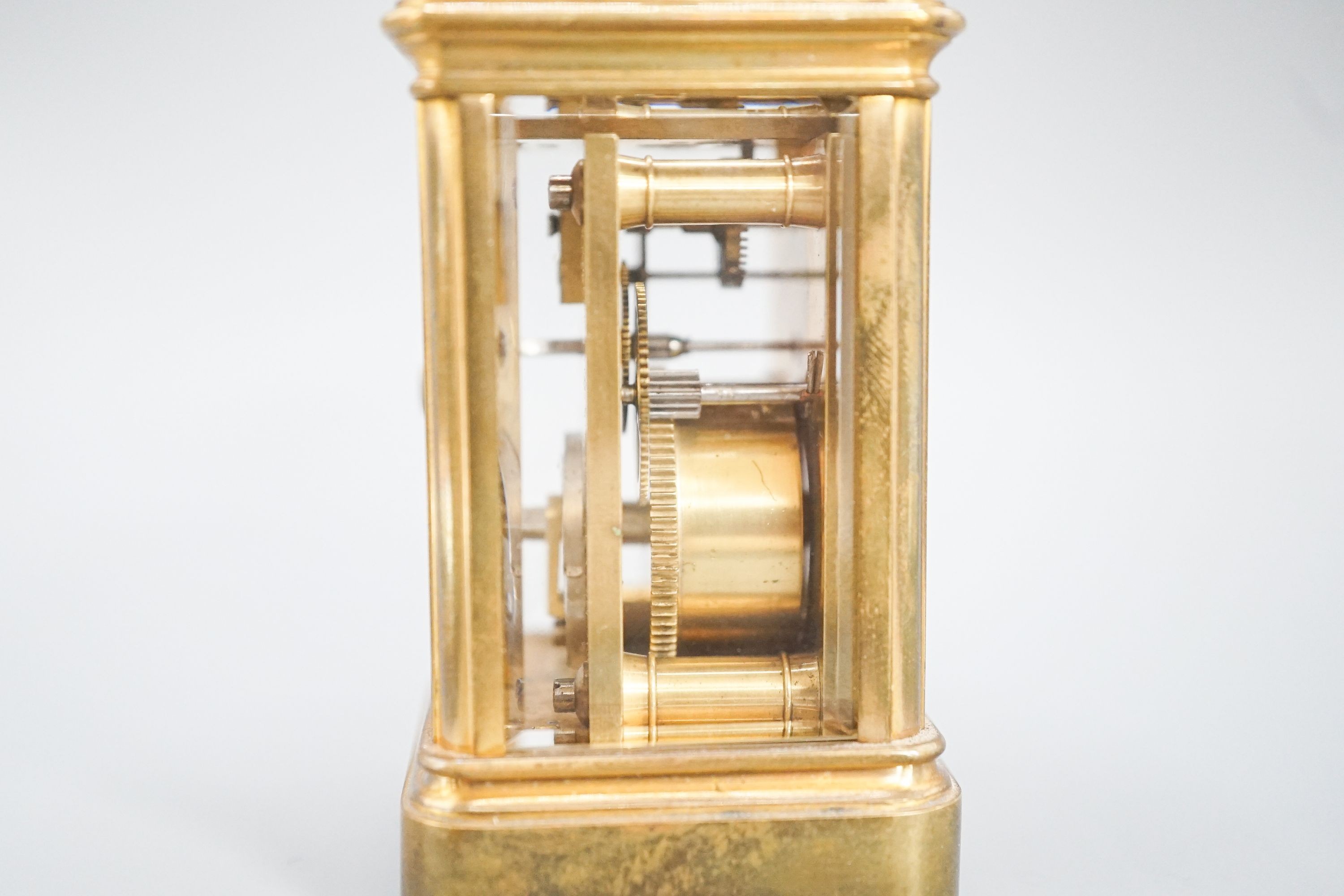 A Henri Jacot brass miniature carriage timepiece, 9.7 cm high with the handle up, cased